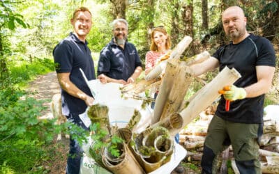 The 75Media team remove plastic tree guards